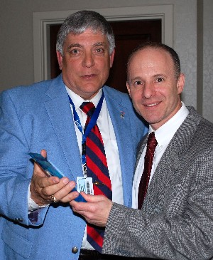At the March meeting, Budura (l) presents Irwin with a token of appreciation from the chapter. 